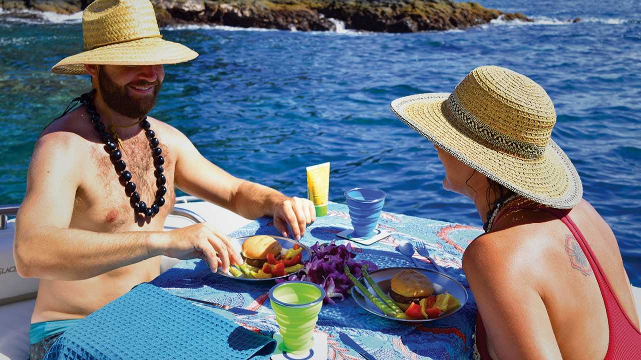 Guests enjoying dining aboard a Maui boat rental
